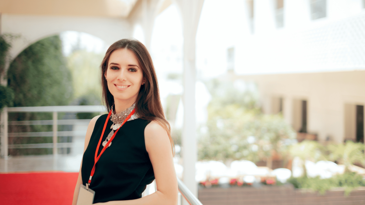 Photo of a young creative professional woman outside wearing a lanyard