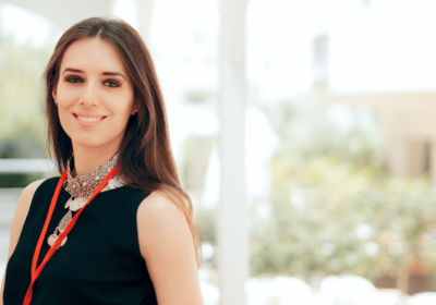 Marketing Assistant Photo of a young creative professional woman outside wearing a lanyard